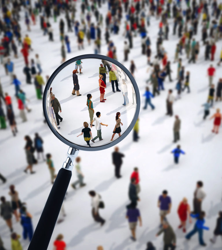 Magnifying glass on a large group of people.